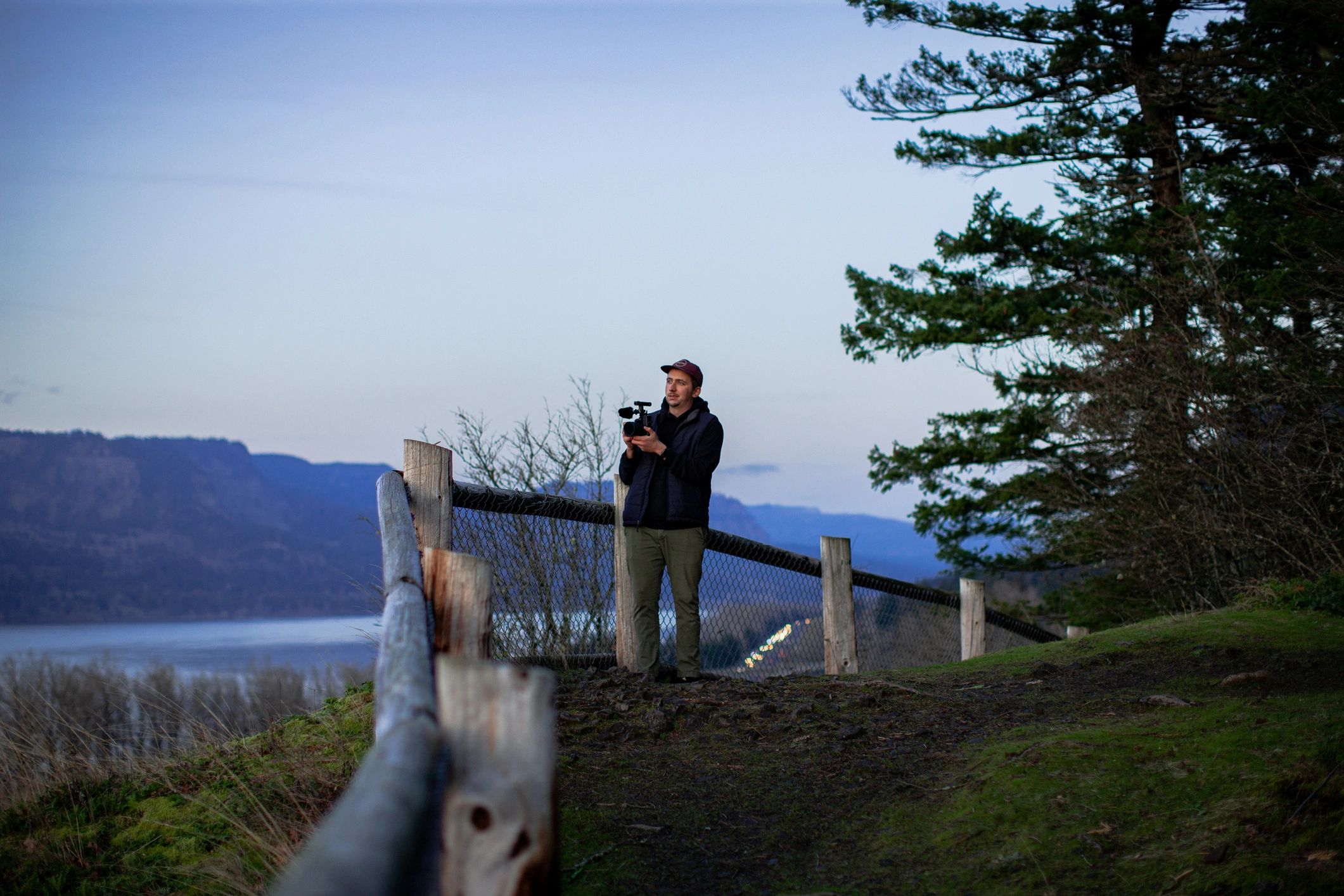 Creative filmmaker capturing outdoor footage at sunset
